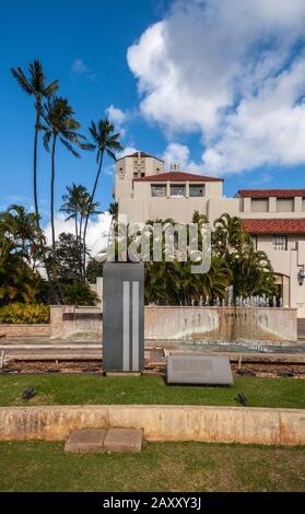 Honolulu  Oahu, Hawaii, USA. - January 10, 2012: 9-11-01 eternal flame and fountain memorial in front of beige City Hall, also known as Hale, under bl Stock Photo