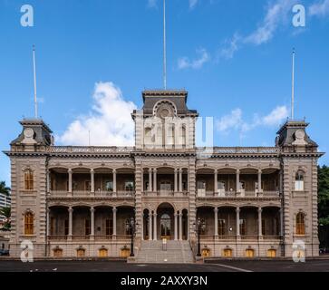 Honolulu  Oahu, Hawaii, USA. - January 10, 2012: Closeup of full frontal gray with pillars facade of Iolani Palace under blue cloudscape and nothing e Stock Photo