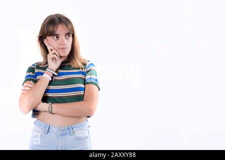 Happy smiling woman thinking and looking sideways Stock Photo