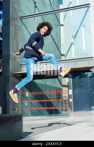 Full length body size profile side view of nice funny handsome cheerful positive sportive guy wearing casual wear in air Stock Photo