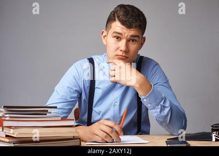 young man in the workplace thinking about something Stock Photo