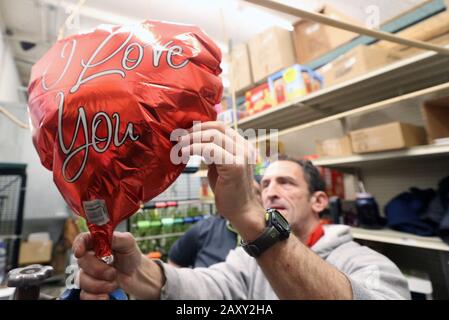 St. Louis, United States. 13th Feb, 2020. Walter Knoll worker, Michael Simmons inflates a balloon for a Valentine flower order, in St. Louis on Thursday, February 13, 2020. Photo by Bill Greenblatt/UPI Credit: UPI/Alamy Live News Stock Photo
