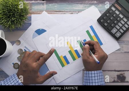 top view of man hand analyzing financial chart on paper  Stock Photo