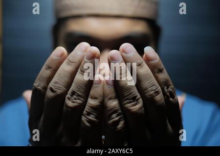 Close up of Muslim man praying at night  Stock Photo