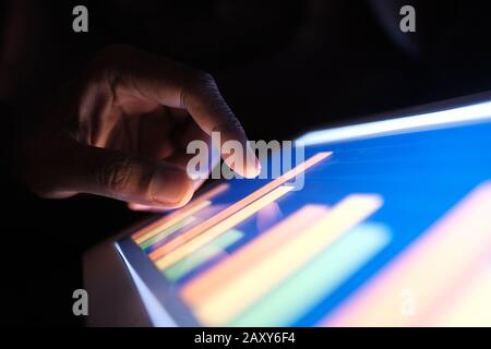 man analyzing chart on digital tablet. Using self created chart  Stock Photo