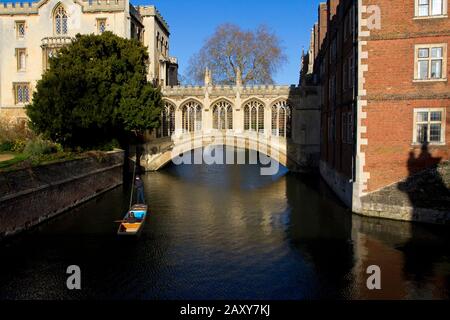 The Bridge of Sighs in Cambridge,England, a covered bridge at St John's College, with people punting along the River Cam towards the bridge