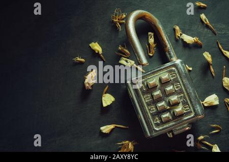 Combination padlock on blackboard background. Top view and copy space. Concept of safety and secret in vintage style. Stock Photo