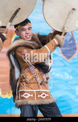 Male expression dancing with tambourine in tradition clothing indigenous inhabitants Kamchatka. Celebration Koryak national holiday Hololo Day of Seal Stock Photo