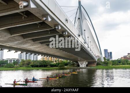 Kayakers lining up ready to race under the Seri Wawasan Bridge on Putrajaya Lake by the Putra Mosque. Stock Photo