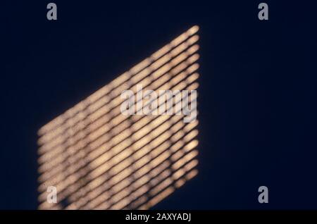 Background photo of dark wooden wall shining from the shadow of window. Stock Photo