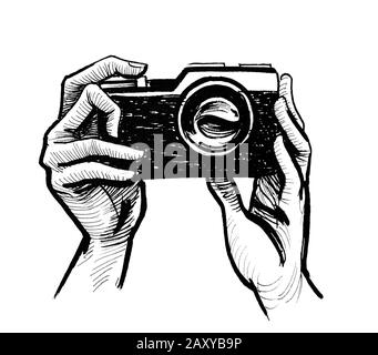 Hands holding retro analog camera. Ink black and white drawing Stock Photo
