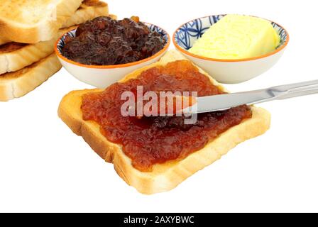 Orange fruit marmalade spread on toast isolated on a white background Stock Photo