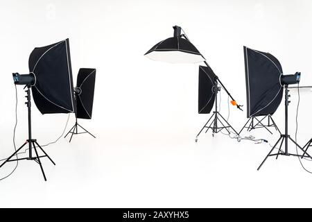 Professional studio lighting soft boxes set up ready for photo shoot session. Stock Photo
