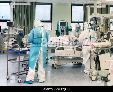 (200214) -- WUHAN, Feb. 14, 2020 (Xinhua) -- Medical staff treat a 14-month-old baby infected with the novel coronavirus in an ICU isolation ward of Wuhan Children's Hospital in Wuhan, capital of central China's Hubei Province, Jan. 27, 2020. A 14-month-old baby infected with the novel coronavirus was discharged from the hospital on Thursday after recovery in central China's Hubei Province. The baby boy was sent to the hospital on Jan. 26 after he had diarrhea and vomiting for six days. However, he still showed symptoms such as shortness of breath after treatment, so he was sent to an ICU i Stock Photo