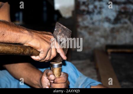 Carpenter working with gouge on table in his workshop Stock Photo