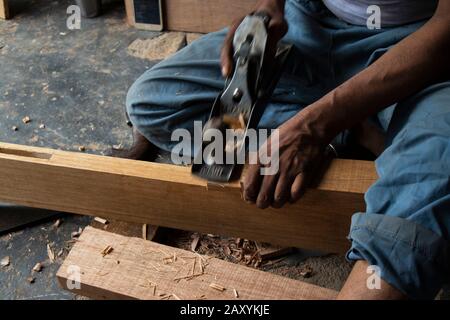 Carpenter working with gouge on table in his workshop Stock Photo