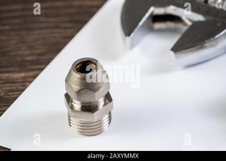 Plumbing pipeline element and adjustable wrench Stock Photo