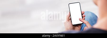 Over The Shoulder View Of The Blank Screen On A Smartphone Stock Photo