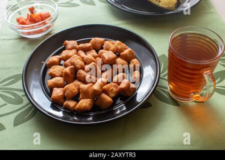 small swahili maandazi on a black plate Stock Photo