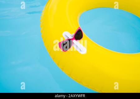 Sunglasses Attached To Ring In Swimming Pool Stock Photo