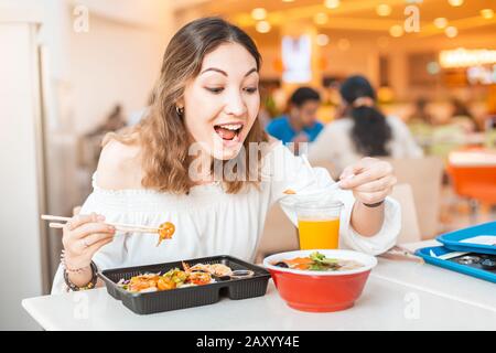 Asian woman eating Japanese bento lunchbox and miso soup in sushi bar Stock Photo