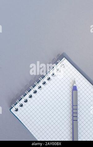 Empty blank ring, spiral notepad with a pen on it. Vertical image of a blank notebook. View from directly above Stock Photo