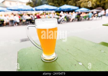 One glass of beer in a beer garden in germany Stock Photo