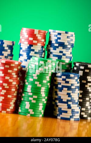 Stack of casino chips against gradient background Stock Photo