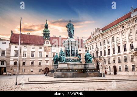 19 July 2019, Vienna, Austria: Sunset cityscape view with Statue of Kaiser Franz I in the courtyard of imperial Hofburg Palace in Vienna, Austria Stock Photo