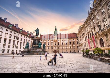 19 July 2019, Vienna, Austria: Sunset cityscape view with Statue of Kaiser Franz I in the courtyard of imperial Hofburg Palace in Vienna, Austria Stock Photo