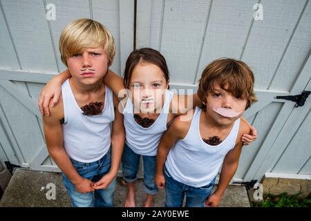 Three children dressed as musclemen, USA Stock Photo