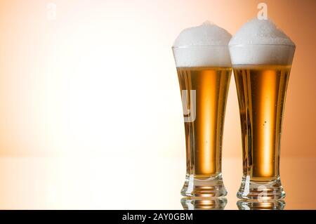 Beer glasses against the colorful gradient background Stock Photo