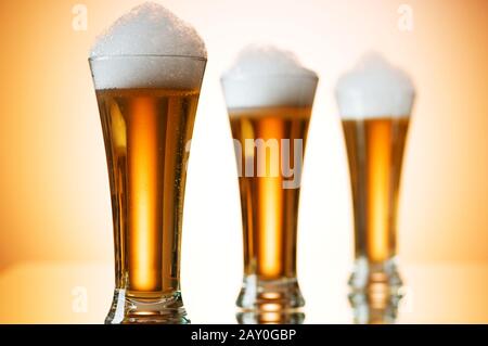 Beer glasses against the colorful gradient background Stock Photo