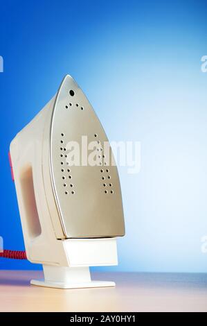 Modern electric iron against the colorful background Stock Photo