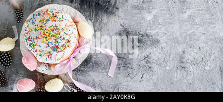 Easter cake with colorful topping and Place setting for Easter on the bright background, Spring holidays concept. Template mockup greeting card with p Stock Photo