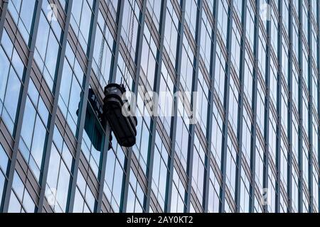Window cleaner cleaning windows on a skyscraper, Indonesia Stock Photo