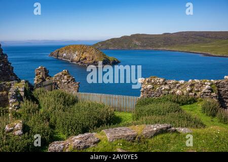 The view looking out from the ruins of Duntulm Castle, on the north coast of Trotternish, Isle of Skye, Scotland, UK. It was the seat of the chiefs of Stock Photo