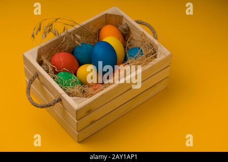 Close Up Of Colored Easter Eggs In wooden  Box Stock Photo