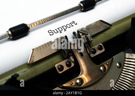 Support text on typewriter Stock Photo