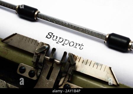Support text on typewriter Stock Photo