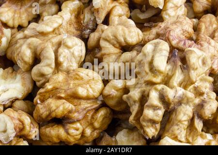 Background texture of walnut kernels. Nut butterflies. Stock Photo