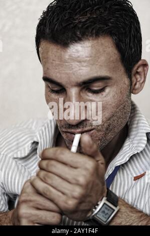 Middle aged man smoking Stock Photo