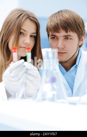 A female and male scientists working in a Lab with a test tubes Stock Photo