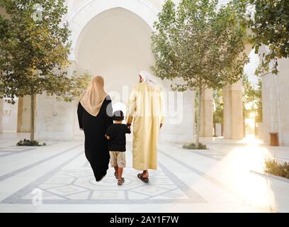 Muslim arabic traditional oriental family walking together, beautiful ambient in front of the mosque Stock Photo