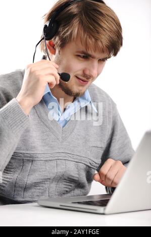 Closeup of a businessman with headset working on laptop Stock Photo