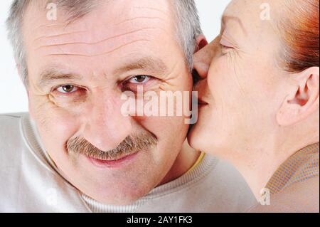 Elderly couple kissing each other Stock Photo