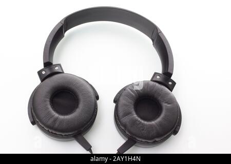 Black headphones isolated on white background. Headset for smartphone. Stock Photo