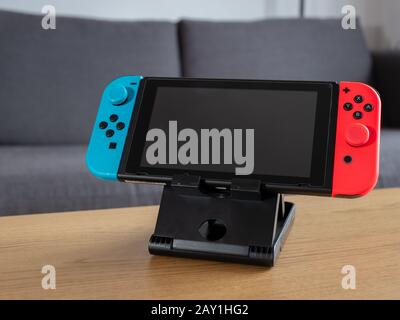 UK - Feb 2020: Nintendo switch hand held console on stand in home setting blank screen Stock Photo