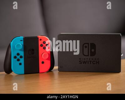 UK - Feb 2020: Nintendo Switch joy con remote controllers and portable console on table Stock Photo