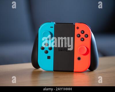 UK - Feb 2020: Nintendo switch blue and red neon joy con grip pad controller for gaming Stock Photo